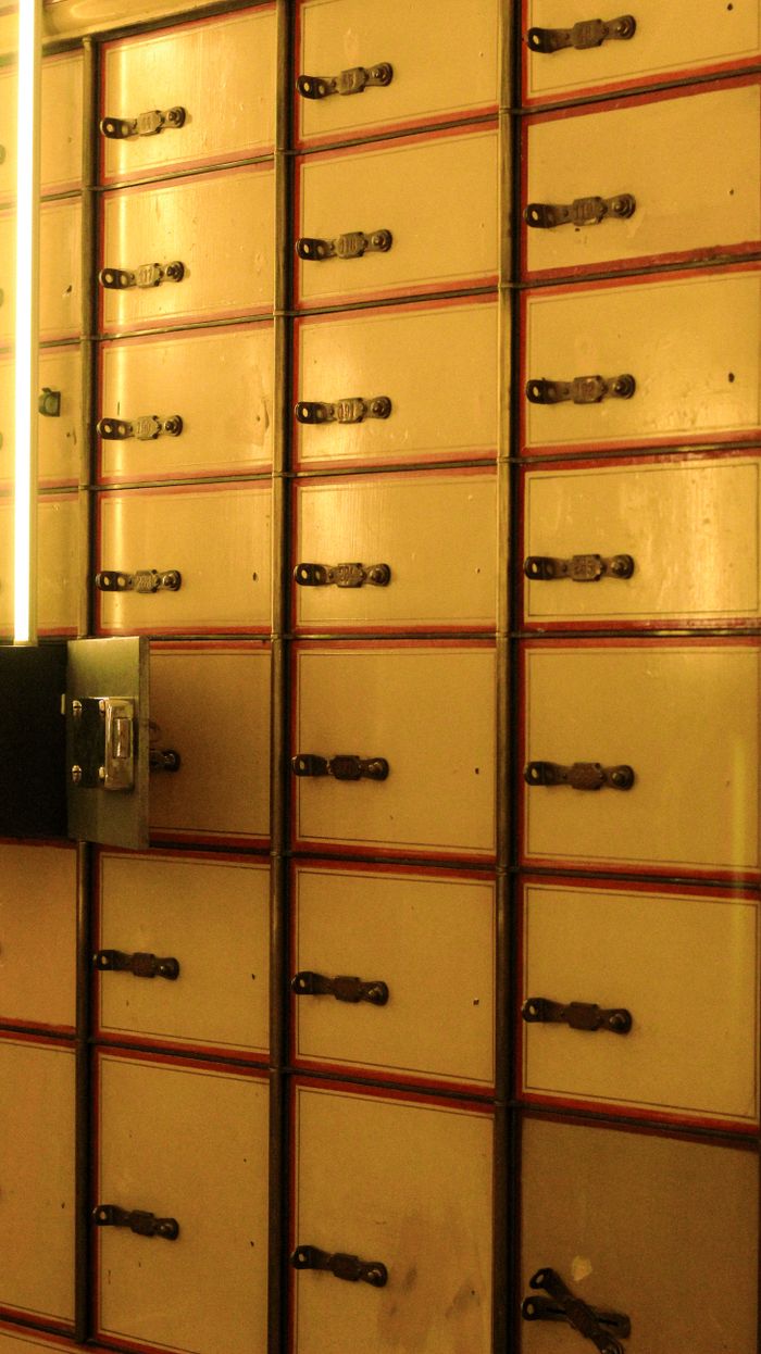 services-03 Close-up of vintage postal lockers with keyholes, evoking nostalgia and security.