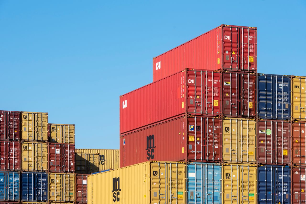 Crafting Captivating Headlines: Your awesome post title goes here A vibrant collection of stacked shipping containers under a clear, blue sky. Ideal for logistic themes.